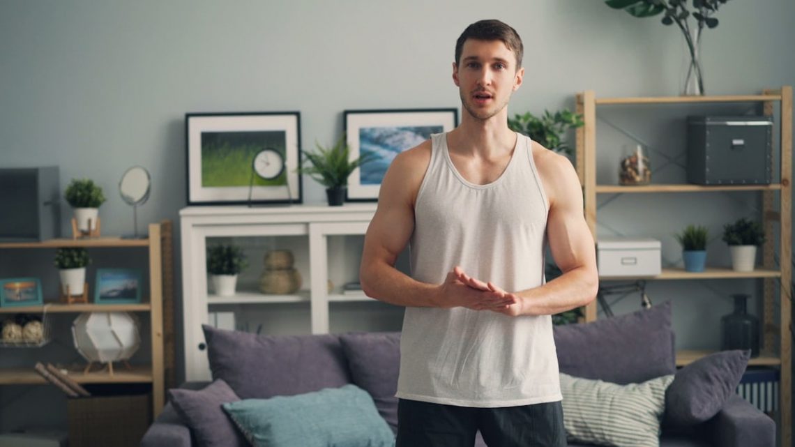 a man standing in front of a couch in a living room