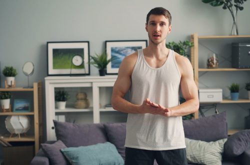 a man standing in front of a couch in a living room
