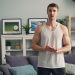 a man standing in front of a couch in a living room